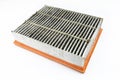 Worn and dirty rectangular car air filter, visible leaves and dirt, isolated on white background with a clipping path, bottom filt Royalty Free Stock Photo