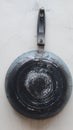 Worn frying pan, blackish blue color