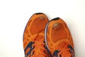 Worn, holey running shoes with real legs sticking out of them Royalty Free Stock Photo