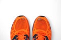 Worn, holey running shoes with real legs sticking out of them. Daily enhanced exercise Royalty Free Stock Photo