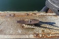 Worn horn cleat, dockline and rubber tire bumpers on wharf