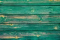 Worn old green horizontal wooden boards with scratches and circles from knots. Royalty Free Stock Photo