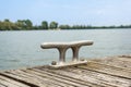 Worn old rusty mooring bollard on the river dock Royalty Free Stock Photo