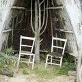 Worn out chairs and hut. Conceptual image