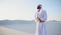 Young male emirate suffers from severe pains in abdomen, standin Royalty Free Stock Photo