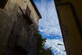 Worn out facade of a building with balconies and a cloudy sky as background Royalty Free Stock Photo