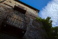 Worn out facade of a building with balconies and a cloudy sky as background Royalty Free Stock Photo