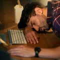 Worn out from the long hours at work. a young businessman sleeping on his desk while working late in an office. Royalty Free Stock Photo
