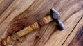 Worn out old hammer on wooden table background Royalty Free Stock Photo