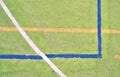 Worn out plastic hairy carpet on outside hanball court. Floor with colorful marking lines. Royalty Free Stock Photo