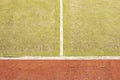 Worn out plastic hairy carpet on outside hanball court. Floor with colorful marking lines. Royalty Free Stock Photo