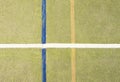 Worn out plastic hairy carpet on outside hanball court. Floor with colorful marking lines. Royalty Free Stock Photo