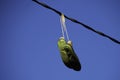 Worn out shoes hanging from a power line