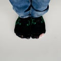 Worn out socks with a hole and toe sticking out of them on white Royalty Free Stock Photo