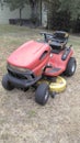 Worn out used red riding lawnmower Royalty Free Stock Photo