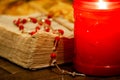 Worn pages of an open Bible book and a rosary beads Royalty Free Stock Photo