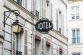 The worn period sign of an hotel and a vintage street light fixed to an old building in Paris Royalty Free Stock Photo