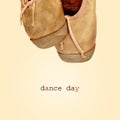 Worn pointe shoes and the text dance day, with a retro effect