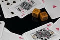 Worn Poker Dice & Deck of Cards on Black Background