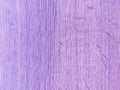 A worn purple wooden wall with scratches and stains. Purple background with texture. The old wall