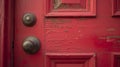 A worn red door with a traditional doorknob.