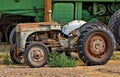 A worn, rusted tractor has been retired.