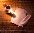 Old paper and feather lit by a lamp Royalty Free Stock Photo