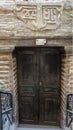 Worn sign and wooden doors for the Cavern Church known as Abu Serga in Coptic Christian Cairo, Egypt. Royalty Free Stock Photo