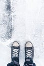 Worn sneakers on grunge pavement