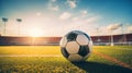 A worn soccer ball on the stadium grass with lights leaks Royalty Free Stock Photo