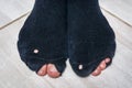 Worn socks with a holes and a fingers sticking out of them