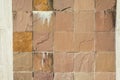 Worn stone mosaics with cracks and calcium carbonate deposits