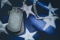 Worn USA military dog tags close up on US American flag with space for text Royalty Free Stock Photo