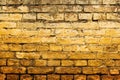 Worn yellow brick wall background