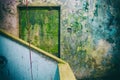 Worn yellow door and blue walls in a condemned building. No people. Royalty Free Stock Photo