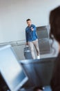 Worried adult man with luggage hurring, outstretching passport and air tickets Royalty Free Stock Photo