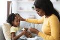 Worried African American Mother Checking Temperature Of Her Ill Female Child Royalty Free Stock Photo