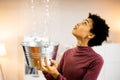 Worried African Woman Holding Bucket While Water Droplets Leak Royalty Free Stock Photo