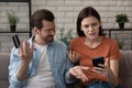 Annoyed couple paying online dissatisfied with bad bank app work