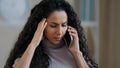 Worried arabic hispanic woman young girl student businesswoman talking mobile phone sit at home disappointed female Royalty Free Stock Photo