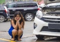 Worried Asian Chinese woman in stress stranded on roadside with car engine failure having mechanic problem needing repair service Royalty Free Stock Photo