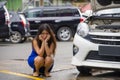 Worried Asian Japanese woman in stress stranded on roadside with car engine failure having mechanic problem needing repair service Royalty Free Stock Photo