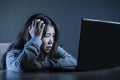 Worried Asian Korean student girl looking depressed and desperate studying with laptop computer in stress for exam feeling frustra Royalty Free Stock Photo
