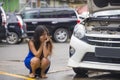 Worried Asian Korean woman in stress stranded on roadside with car engine failure having mechanic problem needing repair service Royalty Free Stock Photo