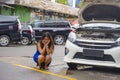 Worried Asian Korean woman in stress stranded on roadside with car engine failure having mechanic problem needing repair service Royalty Free Stock Photo