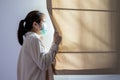 Worried asian woman staying in a room about spread of Corona virus,people at risk of infection with Covid-19,Coronavirus pandemic,