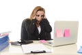 Worried attractive businesswoman in stress working with laptop c