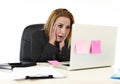 Worried attractive businesswoman in stress working with laptop c