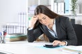 Worried bookkeeper checking calculator at office Royalty Free Stock Photo