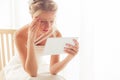Worried bride looking at tablet Royalty Free Stock Photo